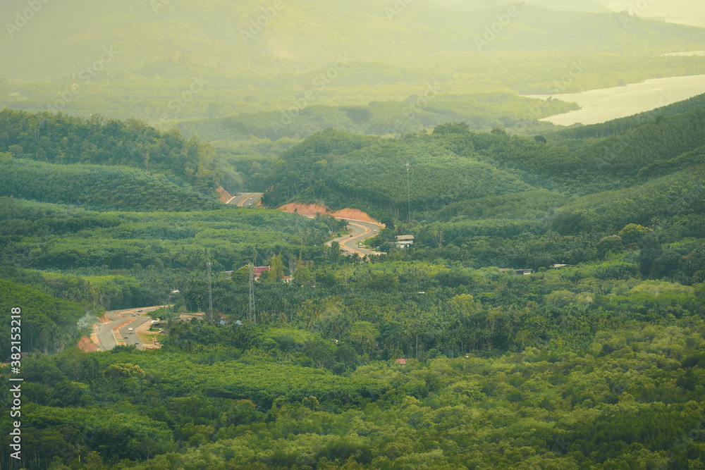 Aerial view of Ranong province with road in green mountain in morning time