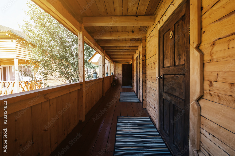 Courtyard and corridor of wooden guest house in mountains