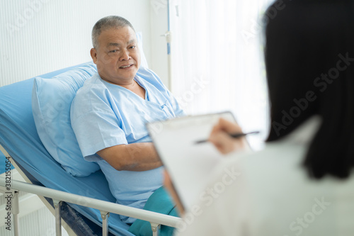 Doctor checking elderly patient health condition after surgery.
