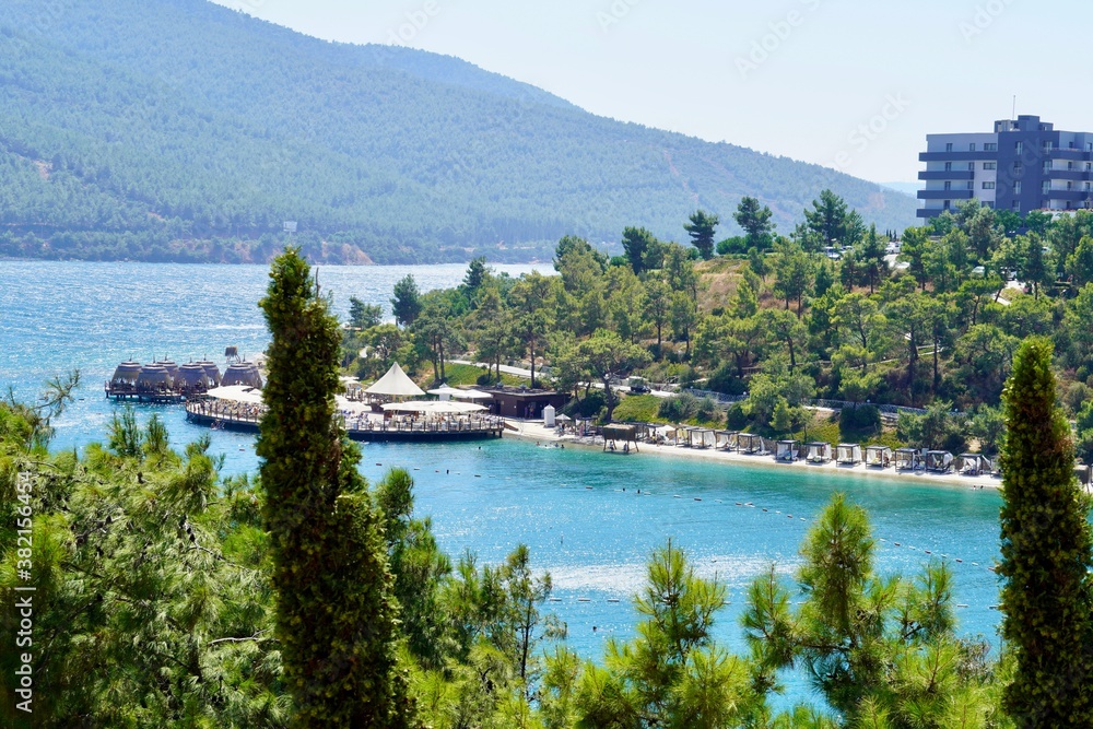 Beautiful panoramic landscape on the emerald bay of the Aegean Sea with green hills, eucalyptus, snow-white yachts. Luxury relax tourism conception