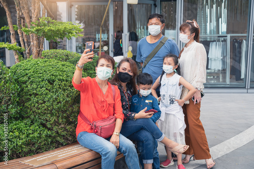 family on vacation wearing face mask