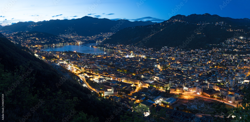 Como - The panorama of the city and lake Como at dusk.