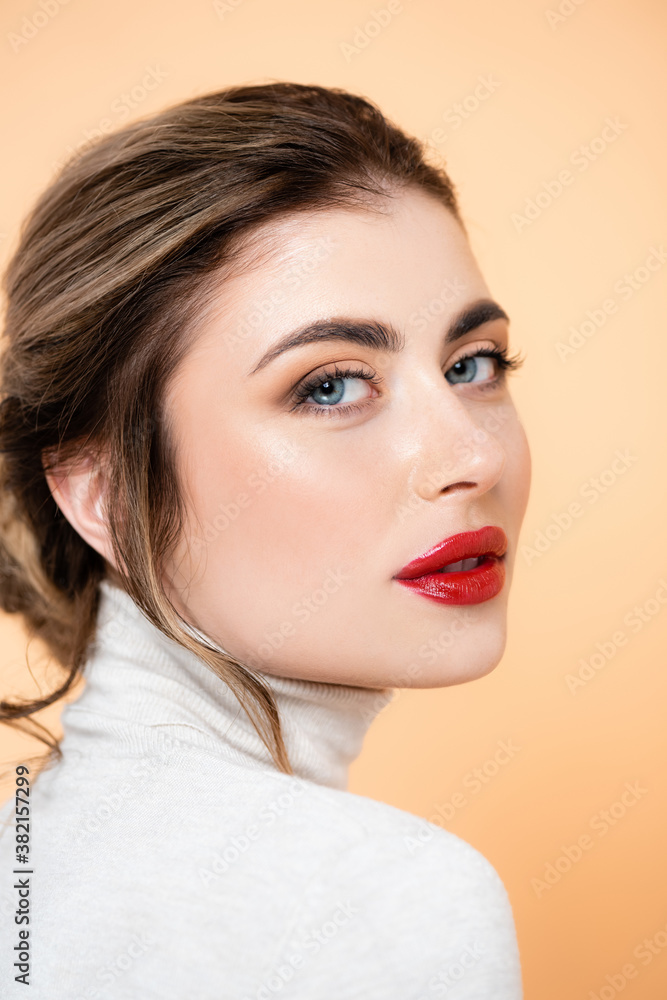 portrait of sensual woman with red lips looking at camera isolated on peach portrait of sensual woman with red lips looking at camera isolated on peach