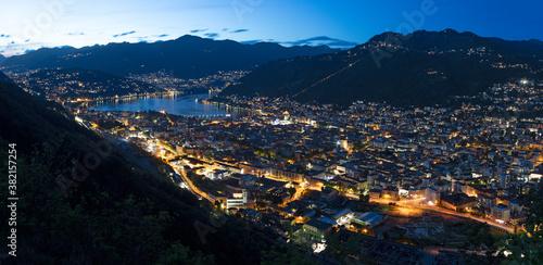 Como - The panorama of the city and lake Como at dusk.