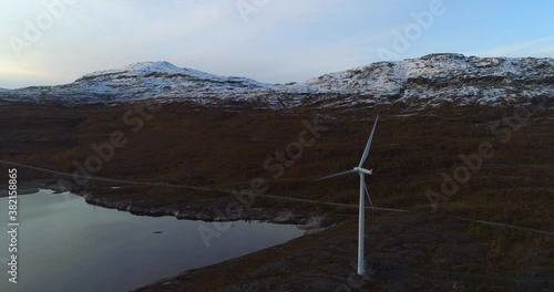 Windmills in north Norway, Aerial view around a moveless wind power turbines, in the highlands of Narvik, autumn sunset, at the Swedish border - pan, drone shot photo