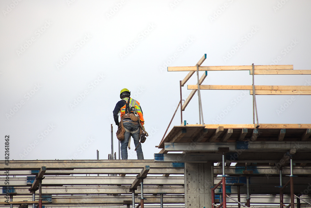 construction site worker at work roof beams construction site worker at work roof beams