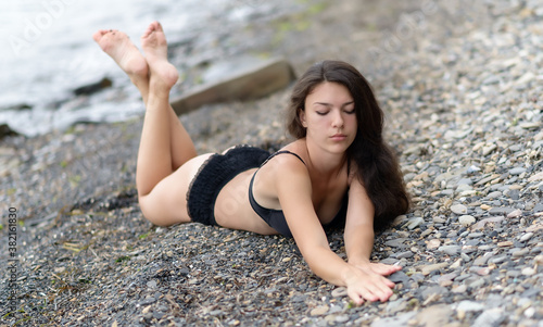 Beautiful woman in black underwear on a beach. Selective focus.