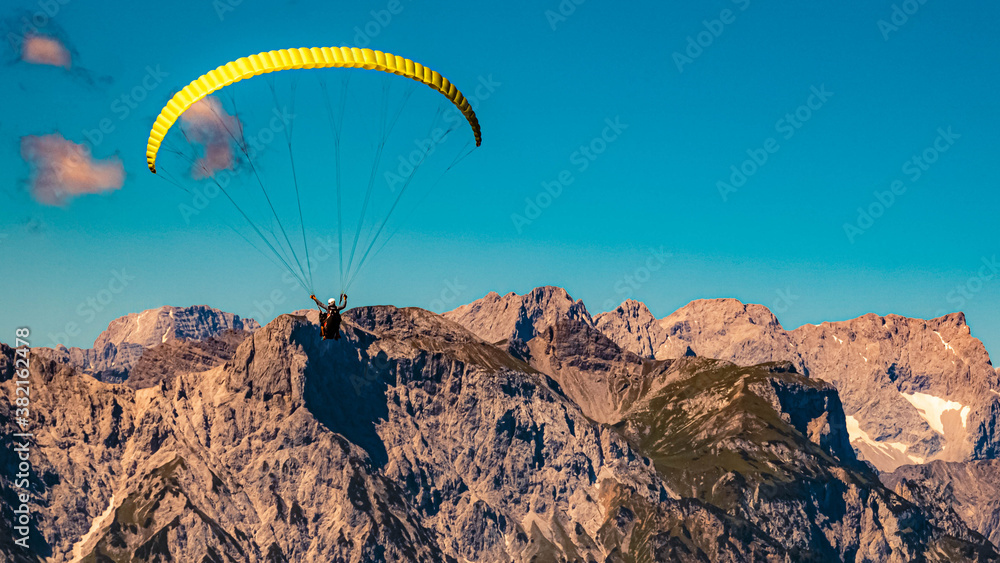 Beautiful alpine view with a paraglider at the famous Rofan summit, Maurach, Achensee, Pertisau, Tyrol, Austria Beautiful alpine view with a paraglider at the famous Rofan summit, Maurach, Achensee, Pertisau, Tyrol, Austria