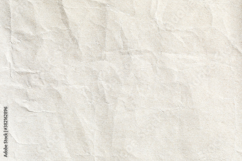 Crumpled paper light beig surface texture 
