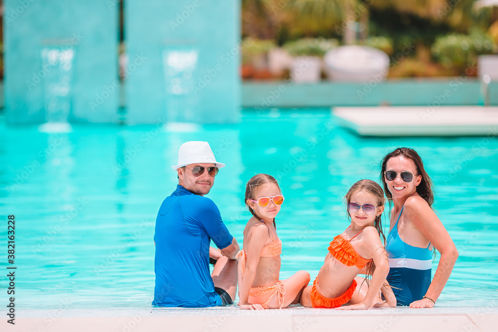 Fototapeta premium Happy family of four on beach vacation together