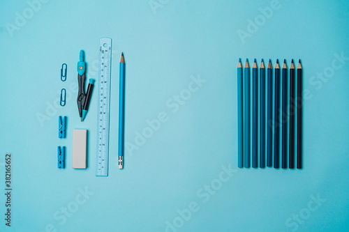 book  pencil  ruler on a blue background.