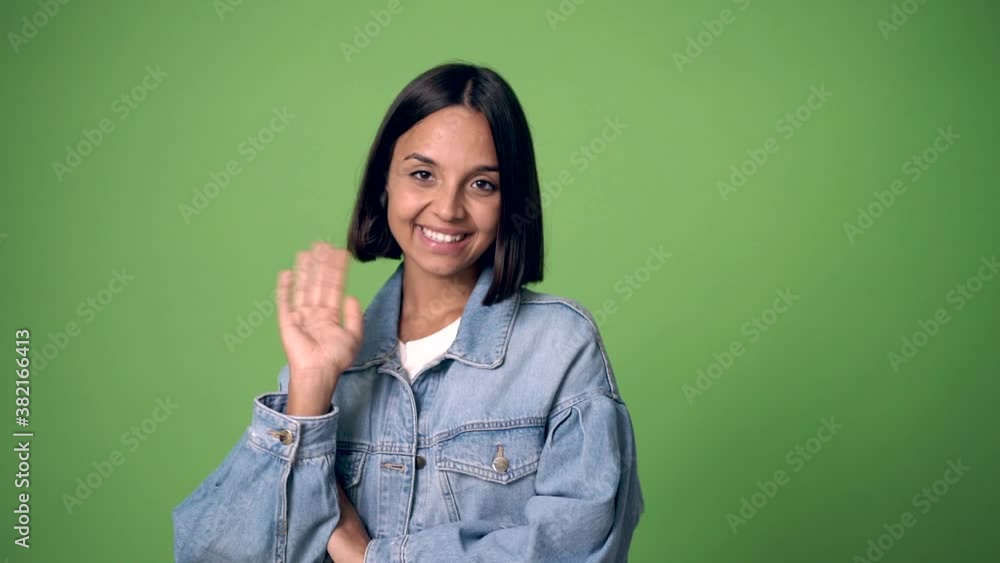 woman saluting with hand with happy expression on green screen chroma key background woman saluting with hand with happy expression on green screen chroma key background