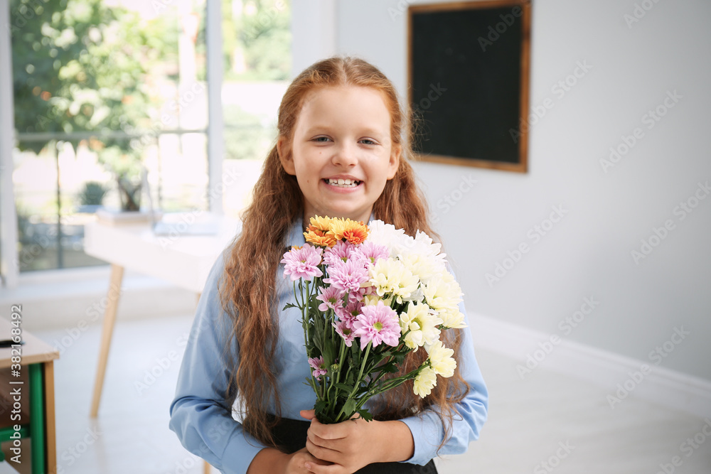 Happy schoolgirl with bouquet in classroom. Teacher's day Happy schoolgirl with bouquet in classroom. Teacher's day
