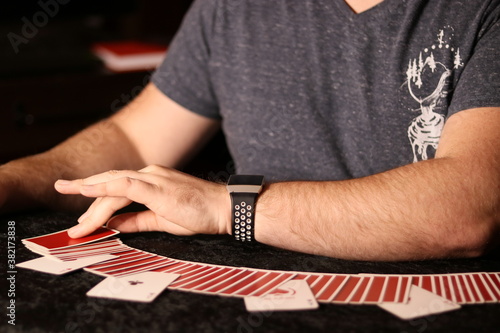 Foto card magician practicing sleight of hand magic