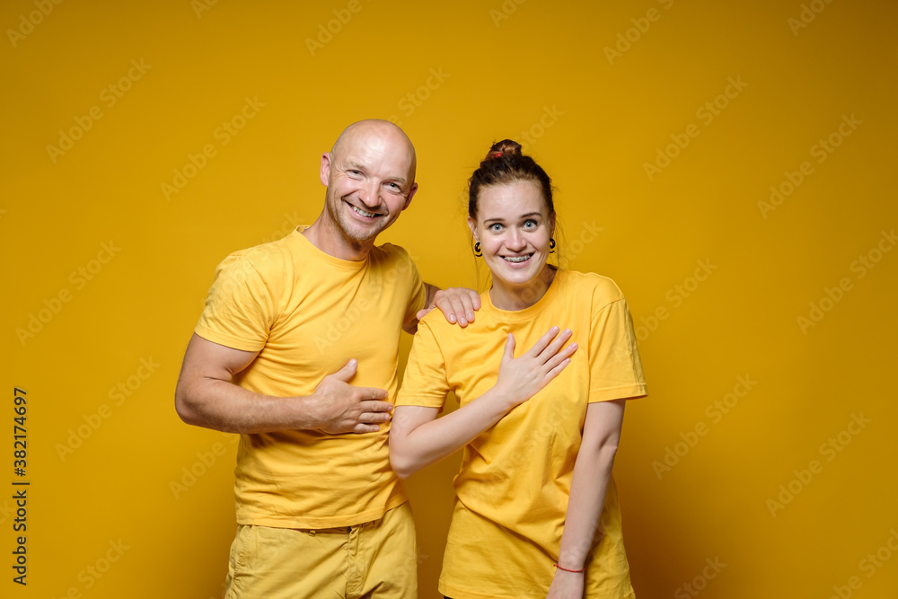 Surprised happy woman and man laugh joyful with their hand on their chest, they are shocked by the surprise or won the lottery. 