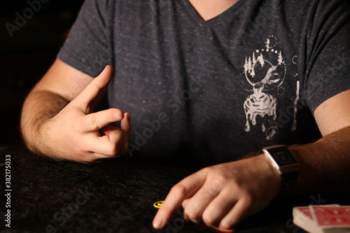 close up of a magician practicing a rubberband trick