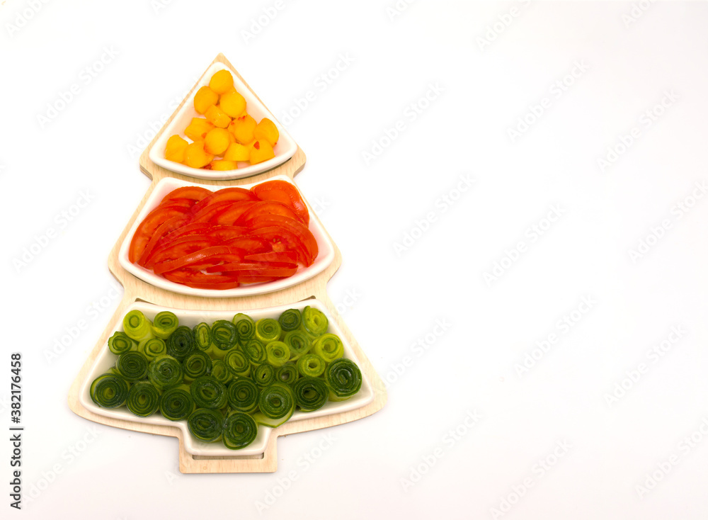 Christmas tree, holiday food for children. Vegetables and fruits are cut in a vase in the form of a Christmas tree. Christmas tree, holiday food for children. Vegetables and fruits are cut in a vase in the form of a Christmas tree.