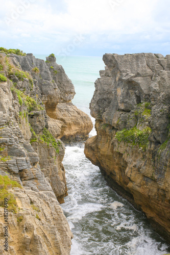 The Pancake Rocks are a heavily eroded limestone area where the sea bursts through several vertical blowholes during high tides. Located on the Paparoa National Park, South Island, New Zealand. © DK_2020