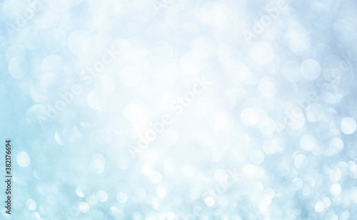 White glitter vintage lights background. Bokeh silver and white. defocused and center copy space.