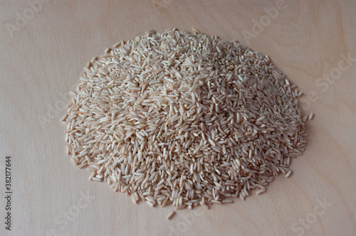 Brown rice on a plywood background