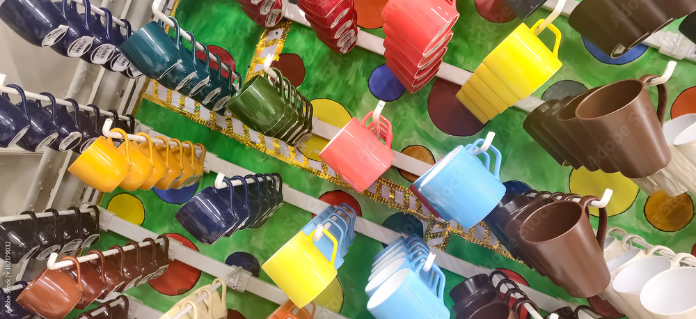 Obraz premium Colored cups are stuck on the stand