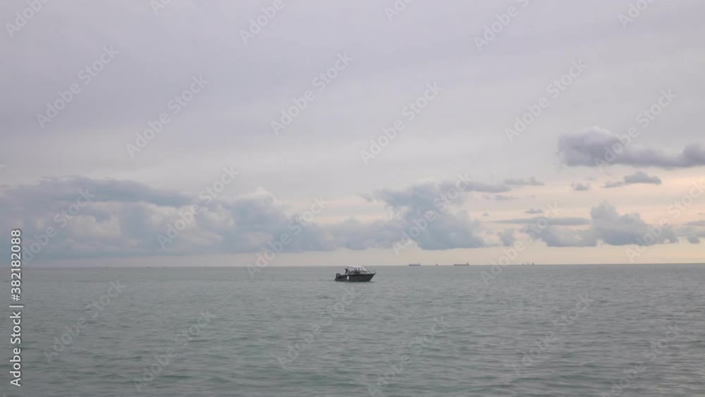 A fishing boat sails on the sea. Autumn sea A fishing boat sails on the sea. Autumn sea