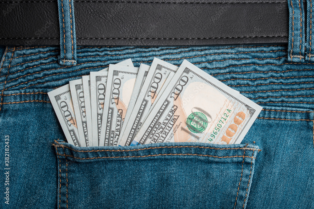 One hundred dollars or 100 dollar bill in the back pocket of jeans. Money United States of America. Bank financing. Cash banknote. One hundred dollars or 100 dollar bill in the back pocket of jeans. Money United States of America. Bank financing. Cash banknote.