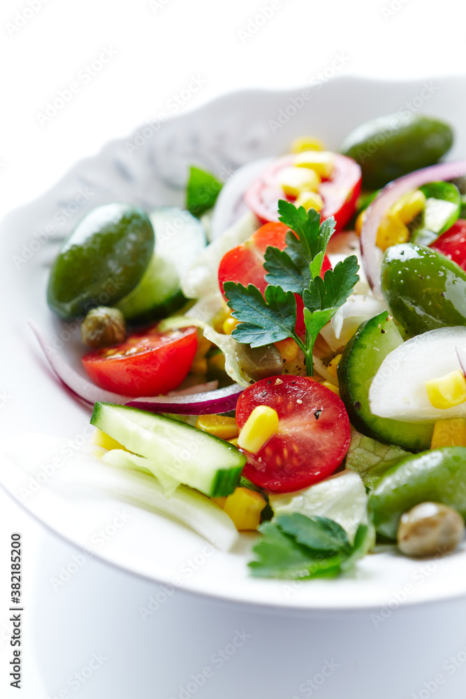 Healthy Salad with Green Olives, Baby Spinach, Cucumber, Cherry Tomatoes and Capers. Bright background. Close up. Healthy Salad with Green Olives, Baby Spinach, Cucumber, Cherry Tomatoes and Capers. Bright background. Close up.