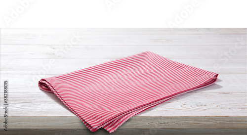 Red napkin on white wooden table top view