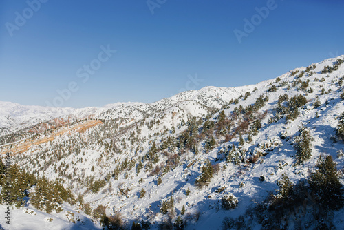 Snow spurs of the Tien Shan in Uzbekistan on a Sunny frosty winter day photo