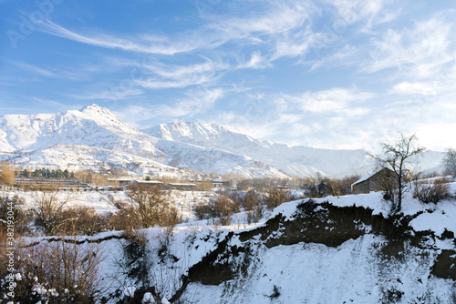 snowy winter landscape on the Tien Shan mountains. Blue sky in the mountains of Uzbekistan