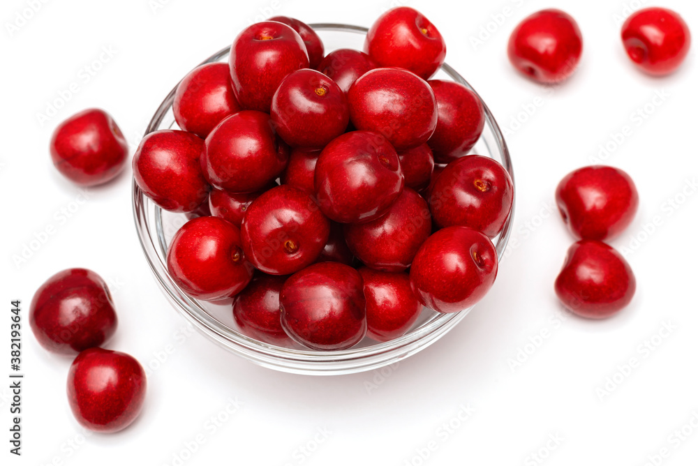 fresh black cherries in a glass plate on a white background fresh black cherries in a glass plate on a white background