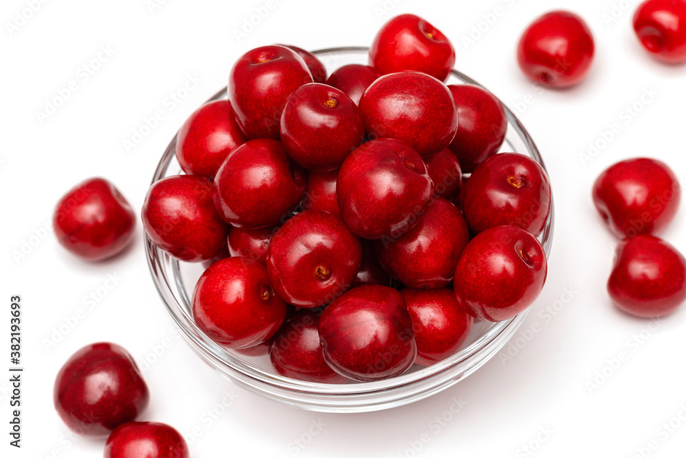 fresh black cherries in a glass plate on a white background fresh black cherries in a glass plate on a white background