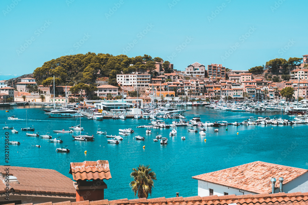 Port of Sóller with houses, pine trees and water