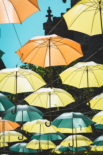 Colorful umbrellas hung across the street creating a pattern