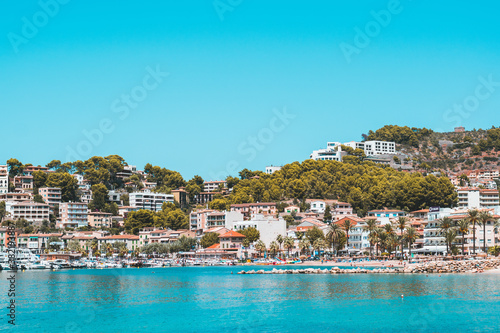 Port of Sóller with houses, pine trees and water © valebenifer