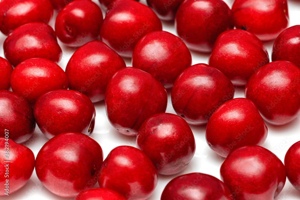 fresh black cherries on a white background fresh black cherries on a white background