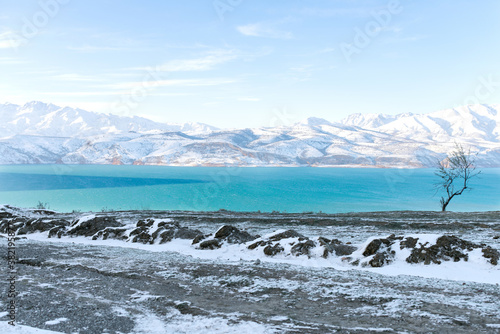 Amazing winter landscape of the Tien Shan mountains and Charvak reservoir on a clear winter day