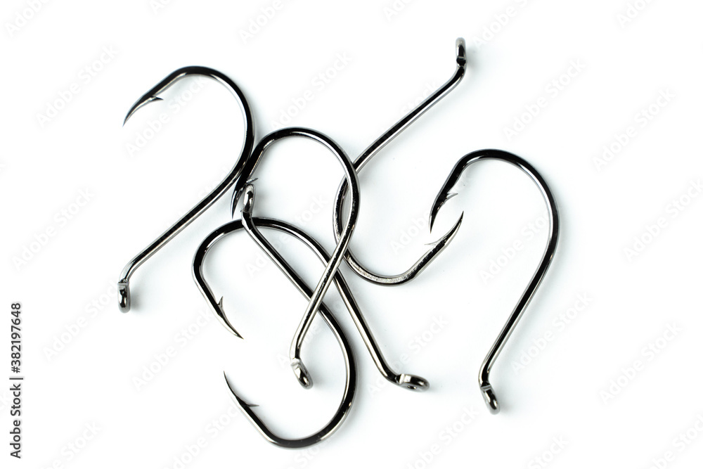 Metal fishing hooks on a white background. Isolated item to insert. Metal fishing hooks on a white background. Isolated item to insert.