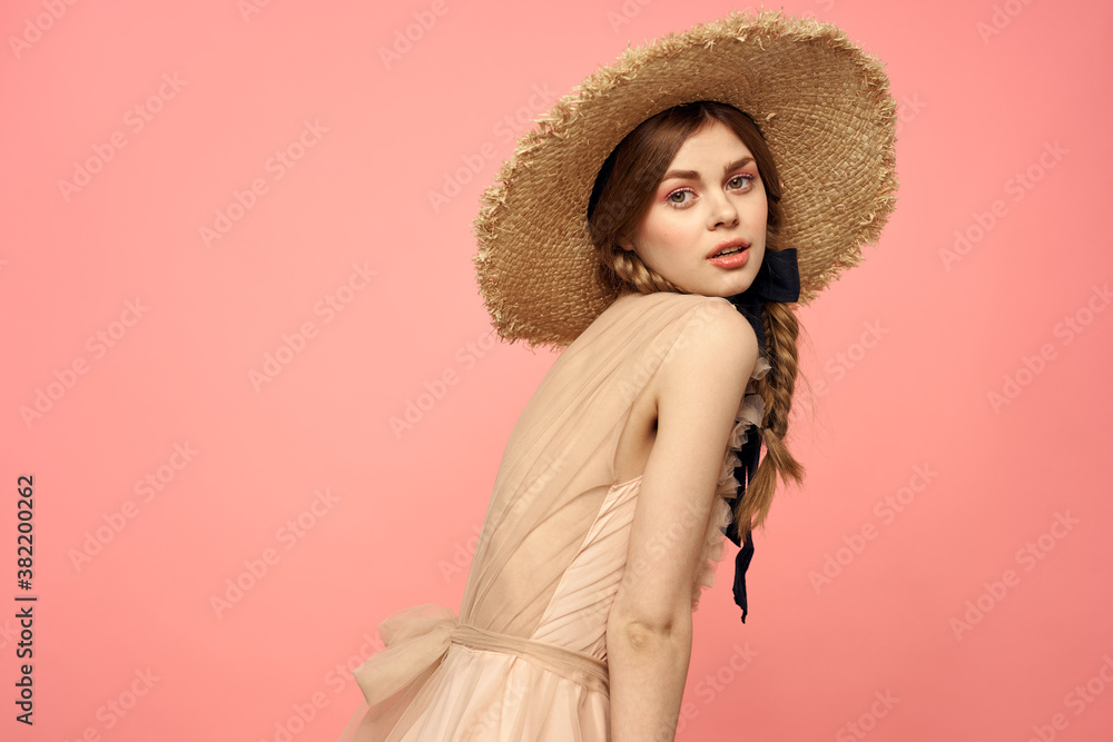 Romantic girl with pigtails and in a straw hat smile romance pink background Copy Space Romantic girl with pigtails and in a straw hat smile romance pink background Copy Space