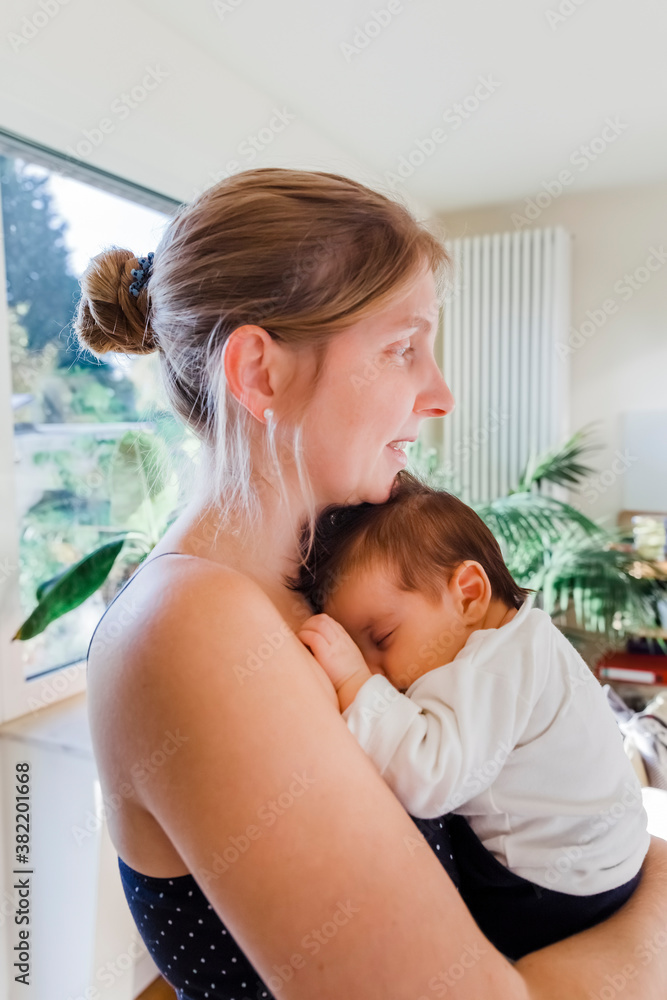 Happy mother holding newborn