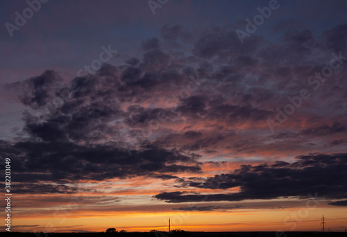 Purple-magenta clouds. Tragic gloomy sky. Landscape with bloody sunset. Fantastic skies on the planet earth. Twilight, nightfall.