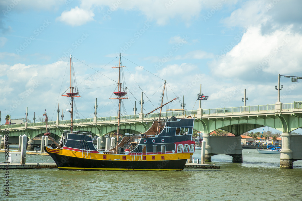 A tall ship replica with the Bridge of Lions in the background. It is a double-leaf bascule bridge that spans the Intracoastal Waterway in St. Augustine, Florida A tall ship replica with the Bridge of Lions in the background. It is a double-leaf bascule bridge that spans the Intracoastal Waterway in St. Augustine, Florida