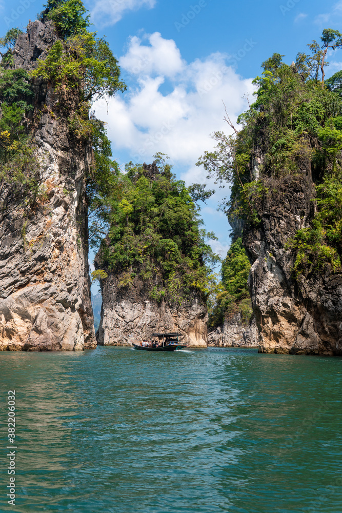 Traditional Long Tail Tour Boat Moving Through The Famous 3 Rocks in Khao Sok National Park, Thailand.
Peaceful, Soothing and Dreamy Place.