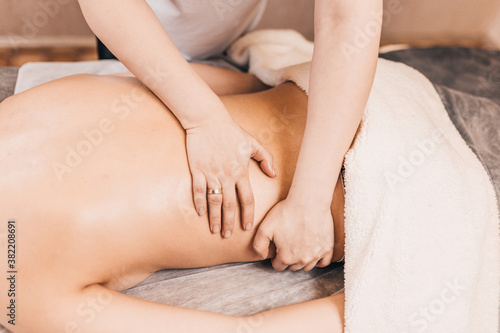 Professional face, back and legs massage in the massage parlor - spa treatments for young skin
