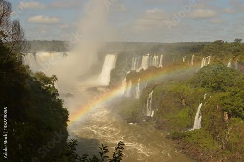 A rainbow over the huge Iguazu River and Waterfalls in Brazil and Argentina