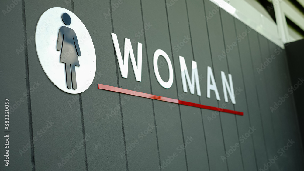 Label of symbol of toilet for women on concrete wall, direction sign and navigation pointer WC restroom Label of symbol of toilet for women on concrete wall, direction sign and navigation pointer WC restroom
