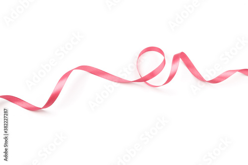 pink satin curly ribbon isolated on white background © Nana_studio