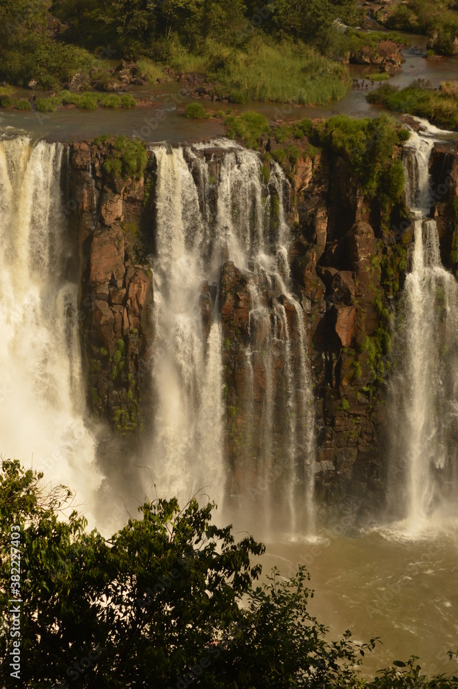 Naklejka premium The powerful and mighty Iguazu (Iguacu) Waterfalls between Brazil and Argentina