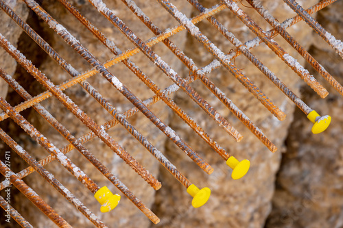 Photos Rusty steel threaded rods bars with yellow protection caps